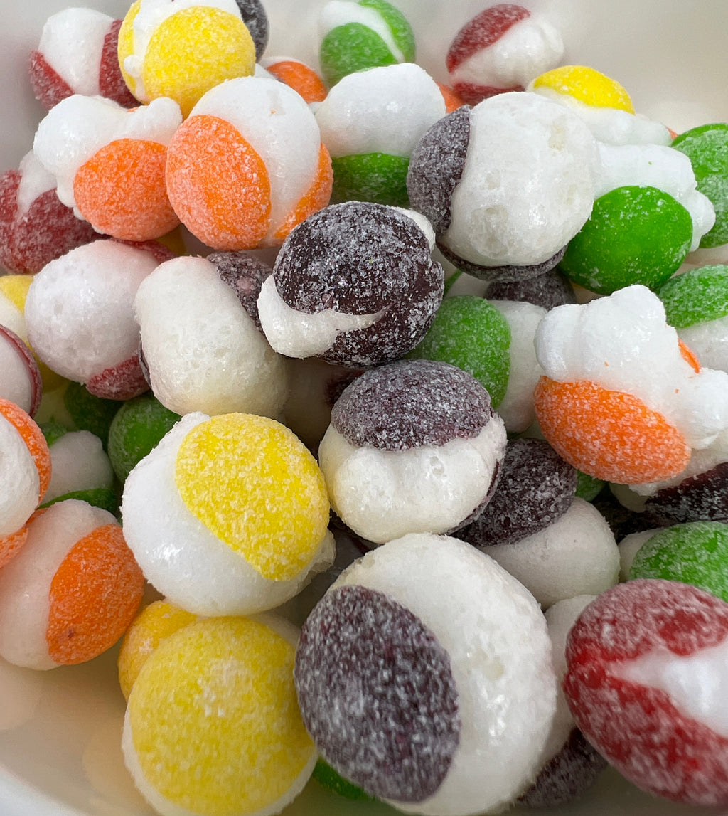 Assorted colorful jelly beans in a white bowl