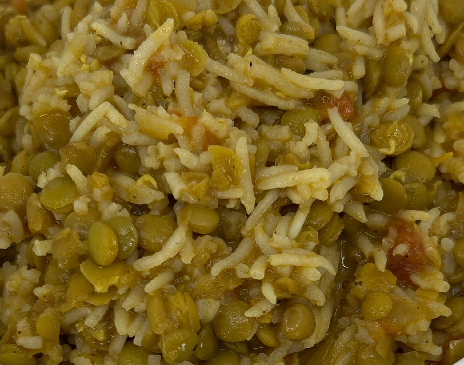 White bowl filled with a greenish dish on a white plate