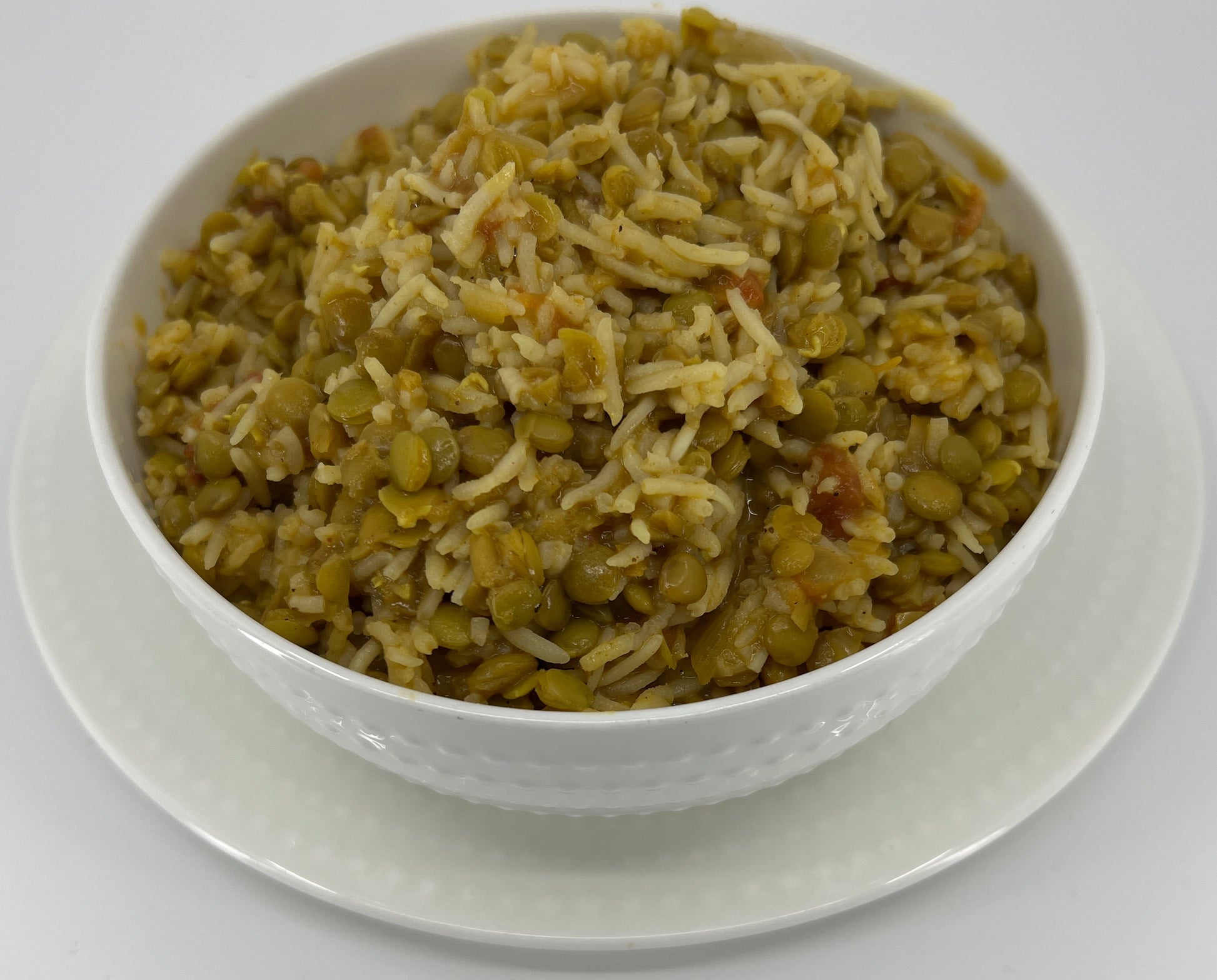 White bowl filled with a mixture of rice and vegetables on a white background